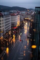 a city street is seen in the rain with buildings in the background