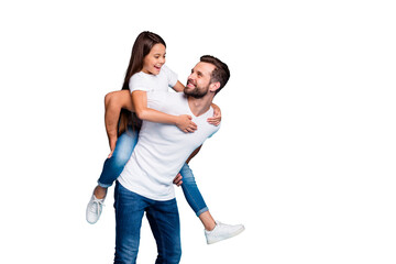 Portrait of cheerful man holding his kid with brunette hairstyle piggyback wearing white t-shirt...