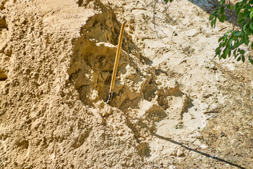 A construction shovel is stuck in a large pile of sand, manual removal of sand, unloading of...