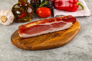 Piece prosciutto crudo over board
