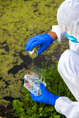 Take a water sample from the river. Selective focus.