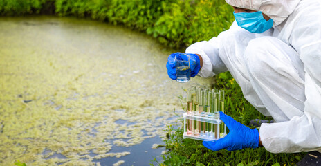 Take a water sample from the river. Selective focus.