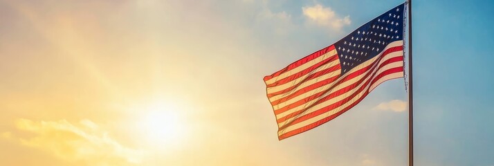 Waving American flag set against a dramatic sky background. Represents freedom and patriotism.