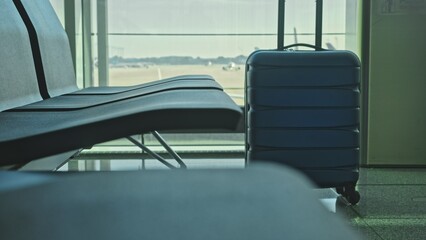 Travel Suitcase Luggage left Unattended at Airport Departures Area Posing Danger and Causing a Security Incident as Potential Bomb Threat Terrorist Attack