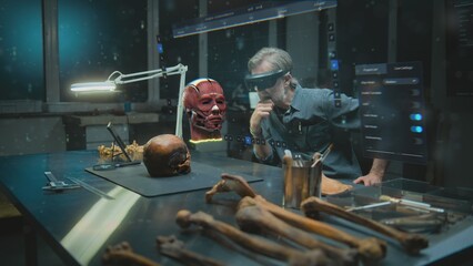 Advanced archaeological lab: Mature archaeologist in VR headset studies ancient human anatomy in...