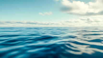 Blue ocean water surface meeting sky with clouds