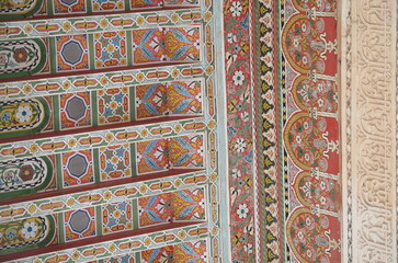 Intricate hand-painted Moroccan ceiling with vibrant geometric and floral patterns Traditional craftsmanship and vibrant colors highlight the detailed artistic heritage of Marrakesh architecture
