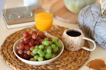 Pumpkins, various food and drinks, fall decorations, books and candles on the table. Fall hygge at home. Selective focus.
