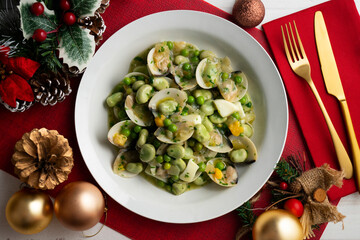 Green beans with clams and hard-boiled egg. Top view table with Christmas decorations.