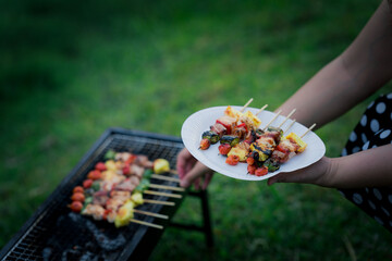 Barbecue Food in nature Cooking on the grill Picnic Holiday in nature Close-up of grilled medium-rare barbecue steak Food concept