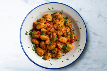 Delicious Italian gnocchi with pesto rosso. Top view table with  decorations.