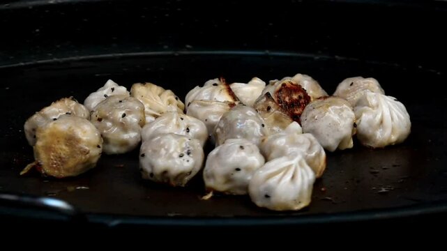 Asian street food fried dumplings being rotated crips and golden brown