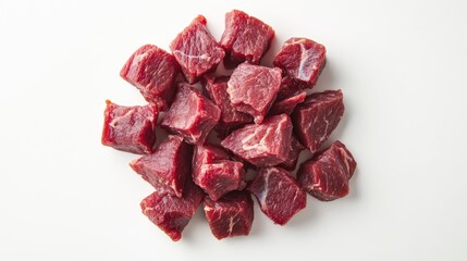 Obraz premium Close-up of raw horse meat pieces arranged neatly on a white background, showcasing its rich texture and perfect for high-end culinary promotions.
