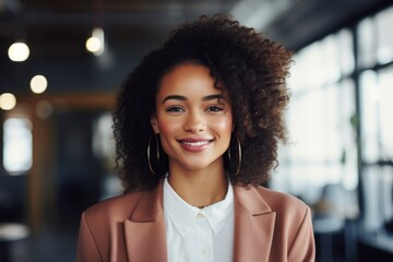 Obraz premium Smiling portrait of a young hipster African American woman in office