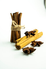 Cut orange and different spices  on white background. Traditional festive winter beverage.Cinnamon, dried orange, anise and cloves