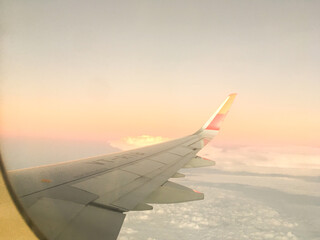Tourism Aspiration Concept - Sky view of wing from Airplane Window - Stock Image