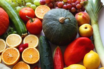 Various seasonal fruits and vegetables on white background. Summer and fall produce. Selective focus.