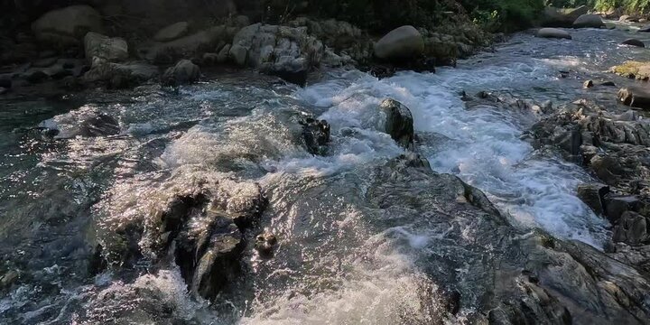 flowing water flowing over rocks in the river