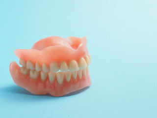 Dentures on a blue background with space for your text or product