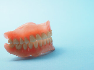 Dentures on a blue background with space for your text or product