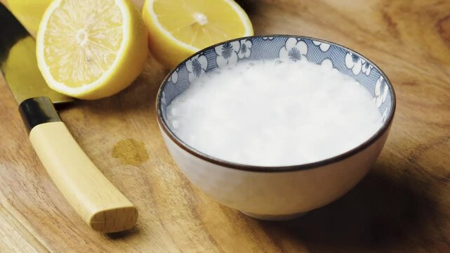 pouring baking soda into citric acid mixture, fizzing and bubbling, effervescent effect