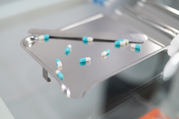 Close-up shot of pill capsules on a pill sorting tray.