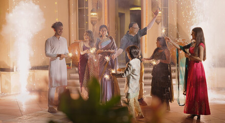 Indian Hindu Asian happy family teen girl boy child hold play crackers make fun joy night decor...