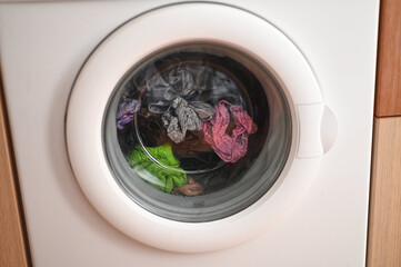 a washing machine in operation washing dirty clothes