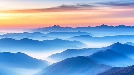Misty mountain landscape with a sunrise sky.