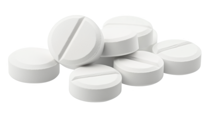 A collection of white pills isolated on a bright surface showcasing their uniform design