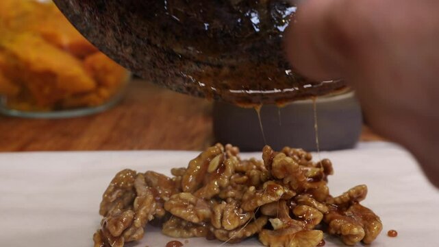 the process of caramelizing pecans in maple syrup to make pumpkin pie