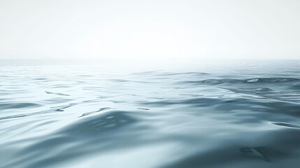 Fototapeta premium A tranquil view of calm water with gentle waves under a soft, hazy light. Ideal for serene and peaceful themes.