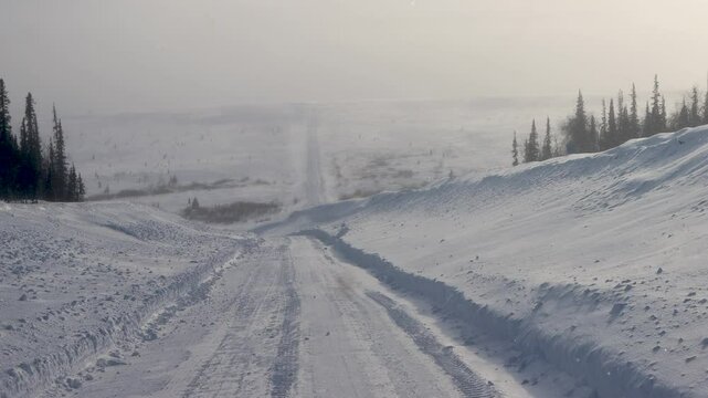 Difficult winter roads in the wide open spaces of Arctic forest-tundra. There is no way here in summer. Russia, Komi Republic oil and gas region, former Soviet Gulag. Siberia