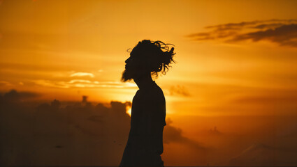 A silhouette of a person against a simple golden sky, emphasizing form over detail