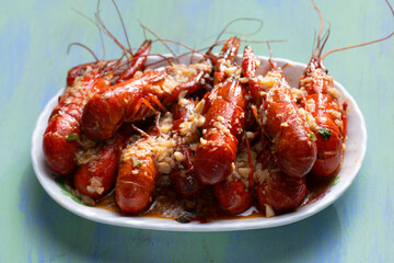 plate of traditional garlicky spicy sichuan red crawfish