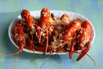 plate of traditional garlicky spicy sichuan red crawfish