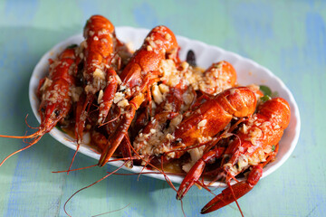 plate of traditional garlicky spicy sichuan red crawfish