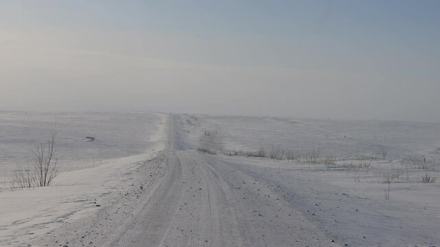 Difficult winter roads in the wide open spaces of Arctic tundra. There is no way here in summer. Russia, Komi Republic oil and gas region, former Soviet Gulag. Siberia