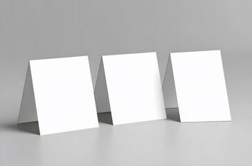 Naklejka premium Three Blank Tent Cards on Gray Background