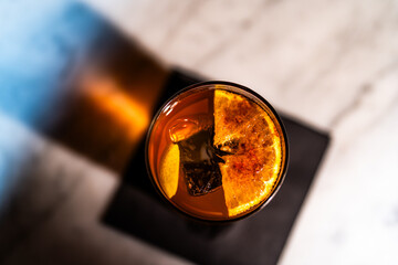 Closeup Landscape Overhead Toasted Orange Cocktail at Upscale Bar