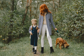 Fototapeta premium Happy family having fun in autumn forest