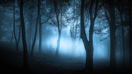 Spooky forest scene at night with eerie fog and ghostly blue lights illuminating the trees. The haunted atmosphere creates a chilling horror background perfect for Halloween or any creepy concept, wit