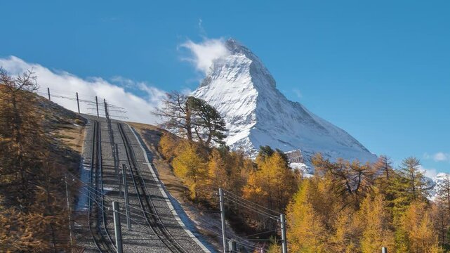 Zermatt Switzerland time lapse of Matterhorn mountain peak and Gornergrat bahn train in Autumn Season