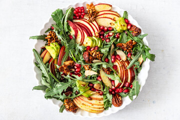 Autumn salad with apple, pomegranate, nuts and honey
