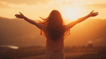 A woman stands with her arms outstretched towards a stunning sunrise over hills, symbolizing a personal journey towards inner peace and happiness.