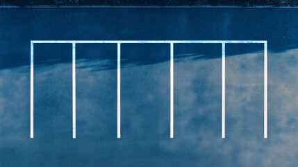 Marked parking spaces designated for car parking, featuring a large parking spot in the center with several smaller parking spots alongside it.