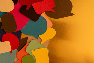 A colorful burst of speech bubbles on a gold background Let s talk