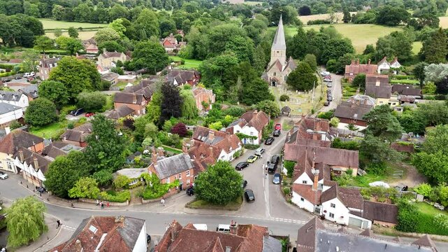 Shere Surrey UK quaint English Village pull back drone aerial reverse reveal