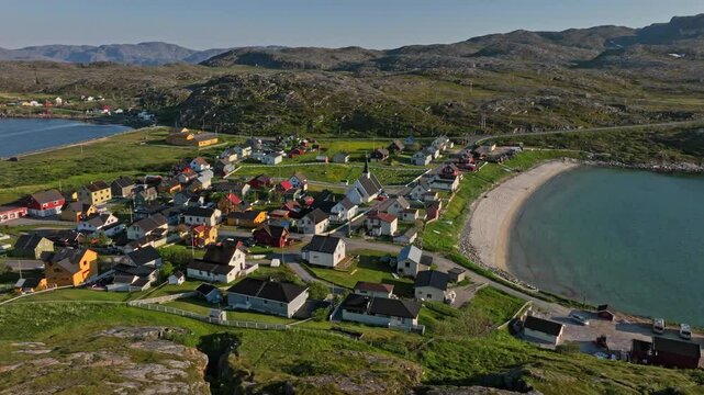 Drone flying sideways in front of the Pykeija town, summer in Finmark, Norway