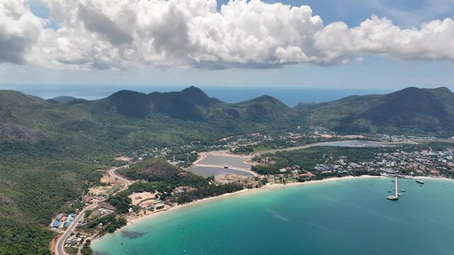 Con Dao Island, Vietnam - A Scenic View of a Coastal Town Framed by Mountains in the Background - Aerial Drone Shot